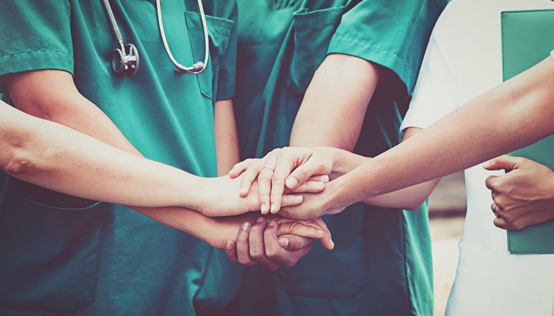 Doctors and nurses coordinate hands. Concept Teamwork