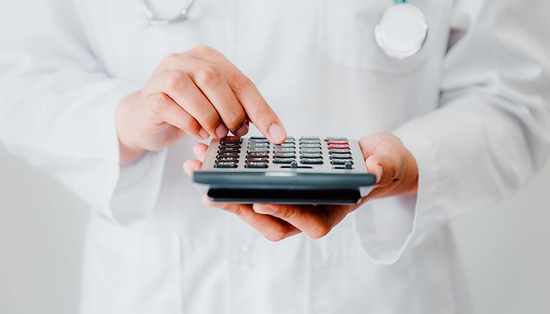 Close-Up of Female Physician Doctor Using Calculator for Calculate Medicine Cost in Office Hospital, Female Medical Practitioner is Calculating Financial Health Insurance in Clinic Medication Room.